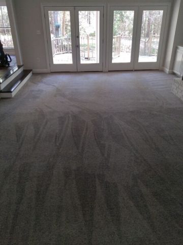 Shepherd's Cleaning LLC technician cleaning carpet via hot water extraction in Bassfield, MS.